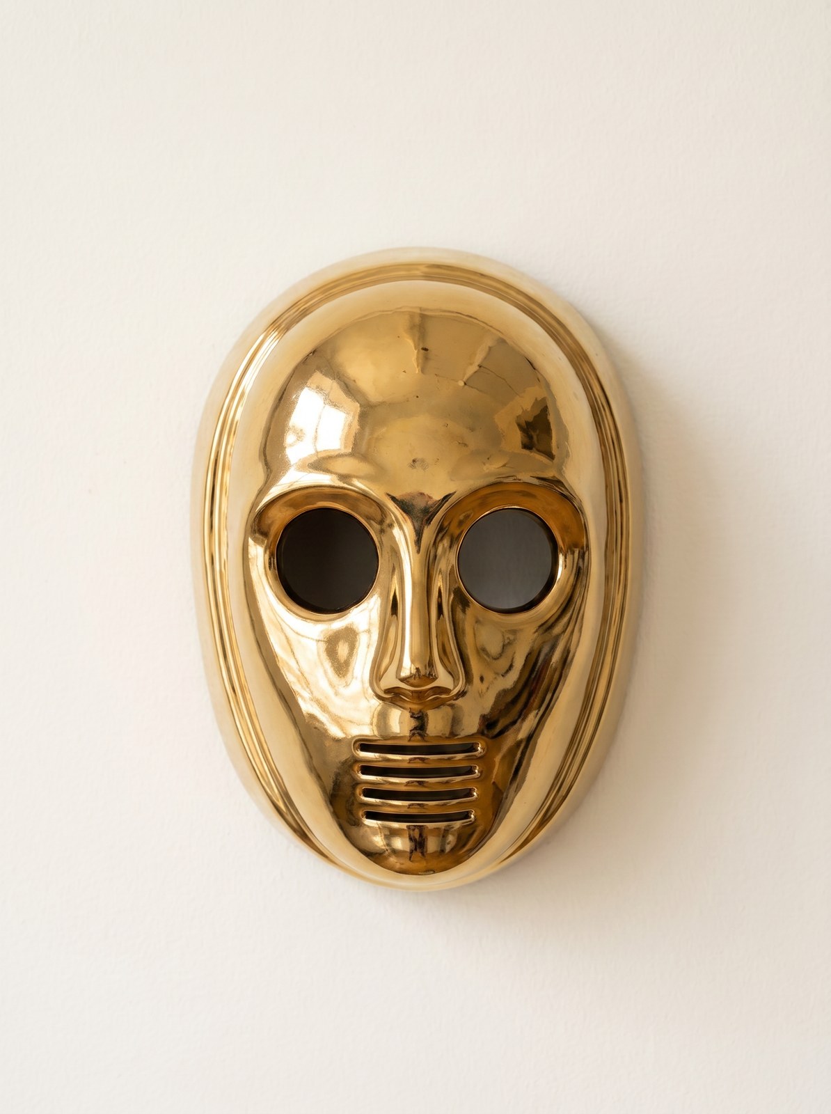 Mirror-gold ceramic humanoid face mask